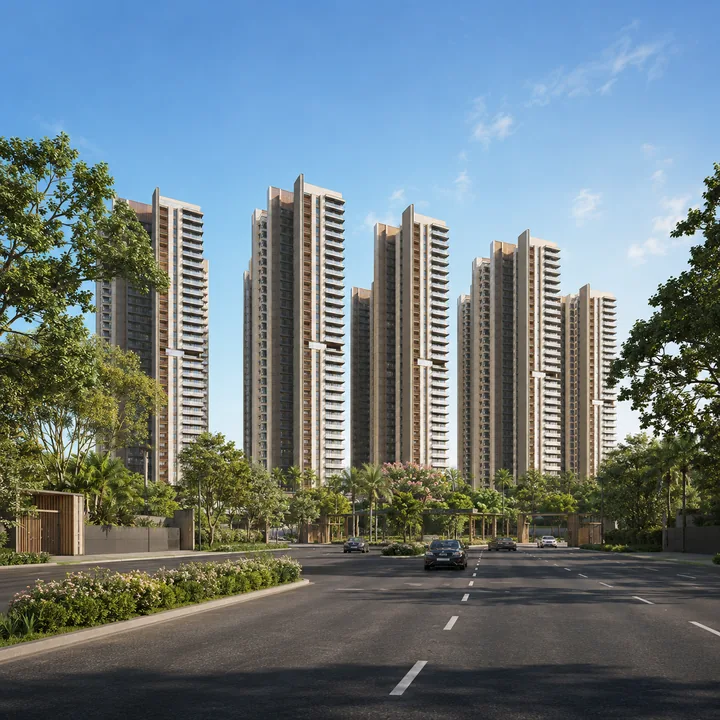 SNN Sarjapur Road arrival along the 30 m approach road, with the gated entry and the towers set back behind planted verges